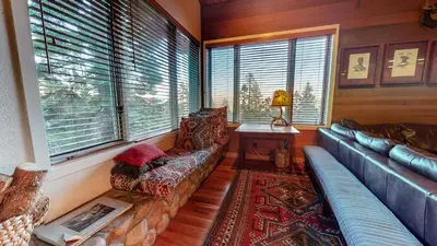 a living room with a couch and a table and windows at Bridges Townhome #09 Condo in Mammoth Lakes