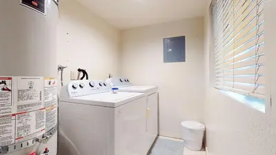 a white bathroom with a sink and a refrigerator at Bridges #105 Condo in Mammoth Lakes