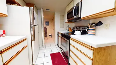 a small kitchen with white counters and a red rug at Bridges #105 Condo in Mammoth Lakes