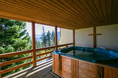 a hot tub in a room with a large window at Bridges Townhome #07 Condo in Mammoth Lakes