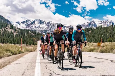 a group of people riding bikes down a road at Sierra Megeve #7 Condo in Mammoth Lakes
