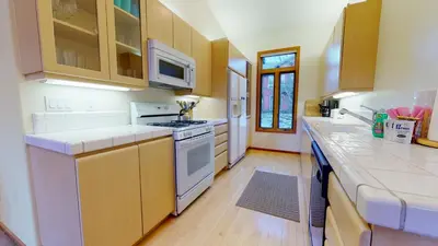 a kitchen with white appliances and wooden cabinets at Snowcreek V #933 Townhouse in Mammoth Lakes