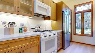 a kitchen with white appliances and wooden cabinets at Snowcreek V #933 Townhouse in Mammoth Lakes
