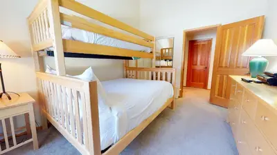 a bedroom with two bunk beds and a desk at Snowcreek V #933 Townhouse in Mammoth Lakes