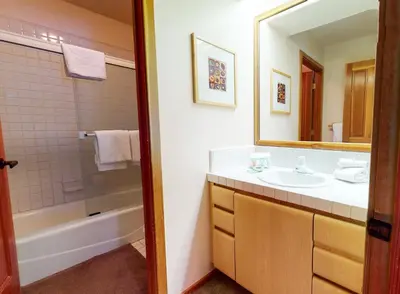 a bathroom with a sink and a shower and a mirror at Snowcreek V #933 Townhouse in Mammoth Lakes