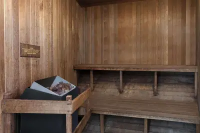 a sauna with wooden walls and a box of logs at Days Inn by Wyndham Rocklin/Sacramento in Rocklin