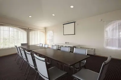a conference room with a long table and chairs at Days Inn by Wyndham Rocklin/Sacramento in Rocklin