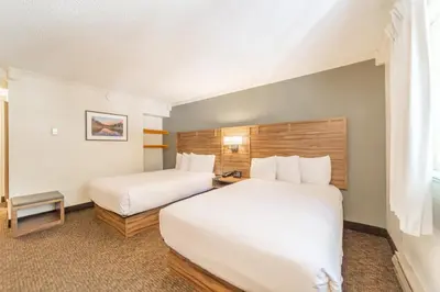 a hotel room with two beds and a window at Alpenhof Lodge in Mammoth Lakes