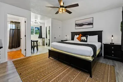 a bedroom with a large bed with a ceiling fan at The Jeffrey Hotel in South Lake Tahoe