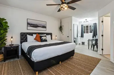 a bedroom with a bed and a ceiling fan at The Jeffrey Hotel in South Lake Tahoe