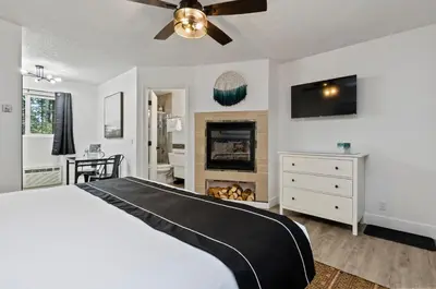 a bedroom with a bed and a fireplace at The Jeffrey Hotel in South Lake Tahoe
