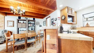 a kitchen and dining room with a wooden ceiling at Snowflower #49 Condo in Mammoth Lakes