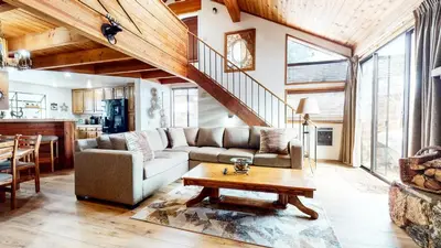 a living room with a couch and a table at Snowflower #49 Condo in Mammoth Lakes