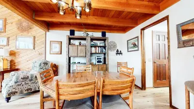 a dining room with a wooden table and chairs at Snowflower #49 Condo in Mammoth Lakes