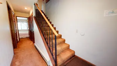 a staircase in a house with a stair railing at Snowflower #74 Condo in Mammoth Lakes