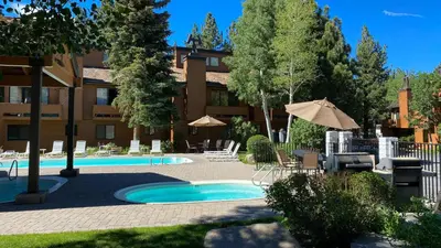 a resort with a swimming pool and a building at Snowflower #74 Condo in Mammoth Lakes