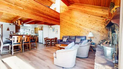 two images of a living room and dining room with wood ceilings at Snowflower #68 Condo in Mammoth Lakes