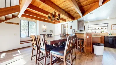 a dining room with a wooden table and chairs at Snowflower #68 Condo in Mammoth Lakes
