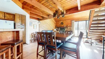 a dining room with a table and chairs at Snowflower #68 Condo in Mammoth Lakes