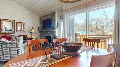 a dining room with a table and a fireplace at Snowcreek II #202 Condo in Mammoth Lakes
