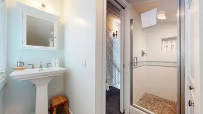 a white bathroom with a sink and a shower at Snowcreek II #202 Condo in Mammoth Lakes