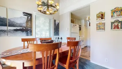 a dining room with a wooden table and chairs at Snowcreek II #202 Condo in Mammoth Lakes
