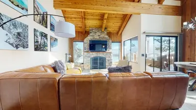 a leather couch in a living room with a fireplace at Val D'Isere #35 Condo in Mammoth Lakes
