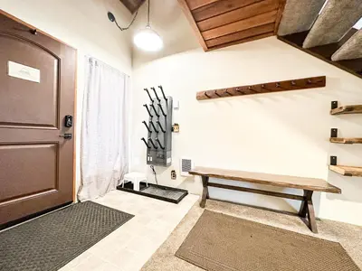 a room with a wooden door and a bench at Val D'Isere #35 Condo in Mammoth Lakes