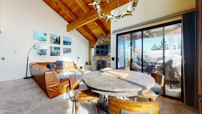a living room with a table and a couch at Val D'Isere #35 Condo in Mammoth Lakes