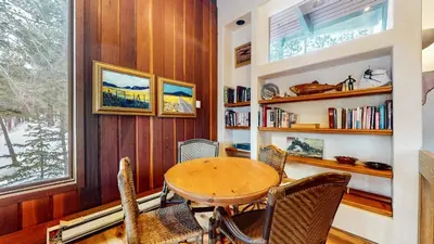 a dining room with a table and chairs and a window at Mammoth West #143 Condo in Mammoth Lakes