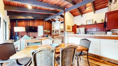 a kitchen and dining room with a wooden table and chairs at Mammoth West #143 Condo in Mammoth Lakes