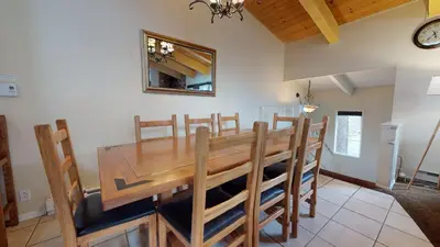 a dining room with a wooden table and chairs at Chateau de Montagne #29 Condo in Mammoth Lakes