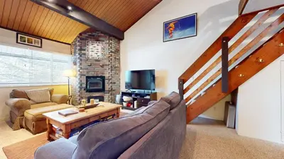 a living room with a couch and a table at Sierra Manors #75 Condo in Mammoth Lakes