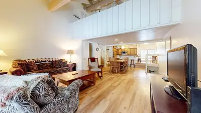a living room with a couch and a table at Snowcreek I #82 Condo in Mammoth Lakes