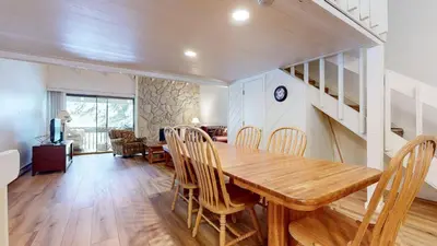 a dining room with a wooden table and chairs at Snowcreek I #82 Condo in Mammoth Lakes