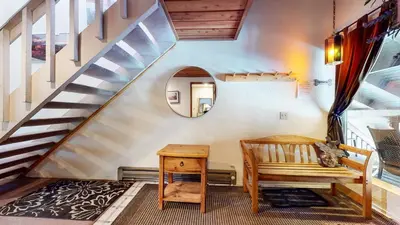a staircase with a bench and a table in a room at Val D'Isere #3 Condo in Mammoth Lakes