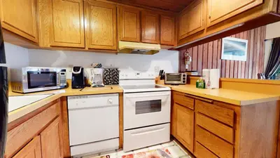 a kitchen with white appliances and wooden cabinets at Val D'Isere #3 Condo in Mammoth Lakes