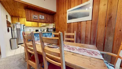 a dining room with a wooden table and chairs at Val D'Isere #3 Condo in Mammoth Lakes
