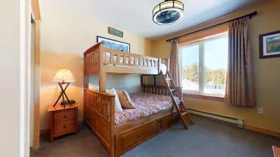 a bedroom with a bunk bed and a window at Juniper Springs Lodge #539 Condo in Mammoth Lakes