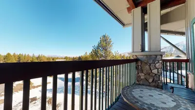 a balcony with a table and a view at Juniper Springs Lodge #539 Condo in Mammoth Lakes