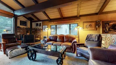 a living room with leather furniture and a coffee table at Condo de los Pinos #16 in Mammoth Lakes