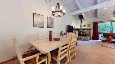 a dining room with a wooden table and chairs at Mammoth West #106 Condo in Mammoth Lakes
