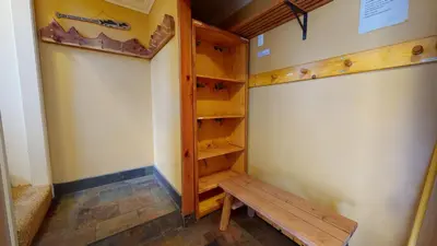 a walk in closet with a bench in the corner at Chateau De Montagne #42 Condo in Mammoth Lakes