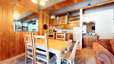 a kitchen and dining room with a wooden table and chairs at Val D'Isere #6 Condo in Mammoth Lakes