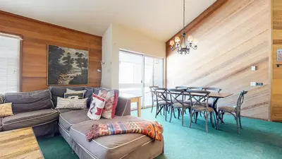 a living room with a couch and a table at Sierra Megeve #8 Condo in Mammoth Lakes