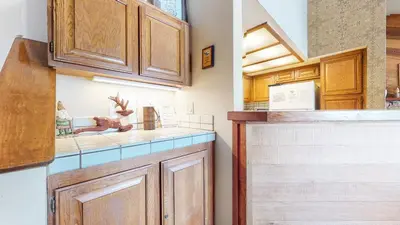 a kitchen with wooden cabinets and a counter top at Sierra Megeve #8 Condo in Mammoth Lakes
