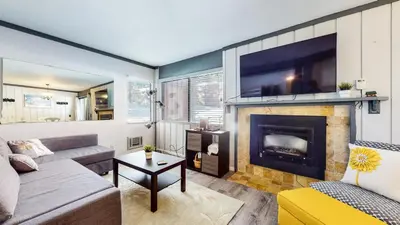 a living room with a couch and a fireplace at Mammoth Ski & Racquet Club #4 Condo in Mammoth Lakes