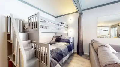 a bedroom with a bunk bed and a couch at Mammoth Ski & Racquet Club #4 Condo in Mammoth Lakes