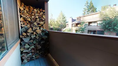 a pile of fire wood on the side of a house at San Sierra #10 Condo in Mammoth Lakes