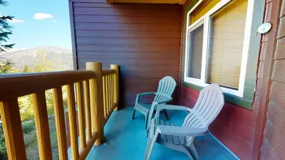 two chairs sitting on the porch of a house at Sunstone #127 Condo in Mammoth Lakes